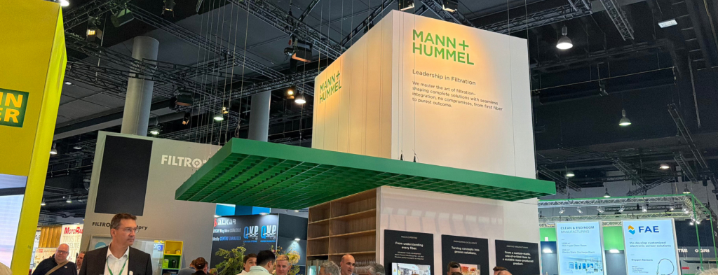 Mann+Hummel Messestand „Leadership in Filtration" auf der Messe Frankfurt Catering und Ausstellungsbereich mit grünem Canopy-Element.